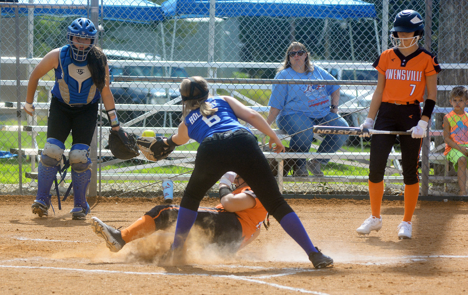 Kate Blankenship (center) slides safely into home plate under the tag of Holliday during Owensville’s 8-4 victory over their Gasconade County rivals in two innings due to the jamboree time limit rule. Owensville will open their season this weekend at Sullivan’s Campbell-Chapman Sports Complex as part of the Peoples Bank Back to School Softball Classic hosted by Sullivan High School.